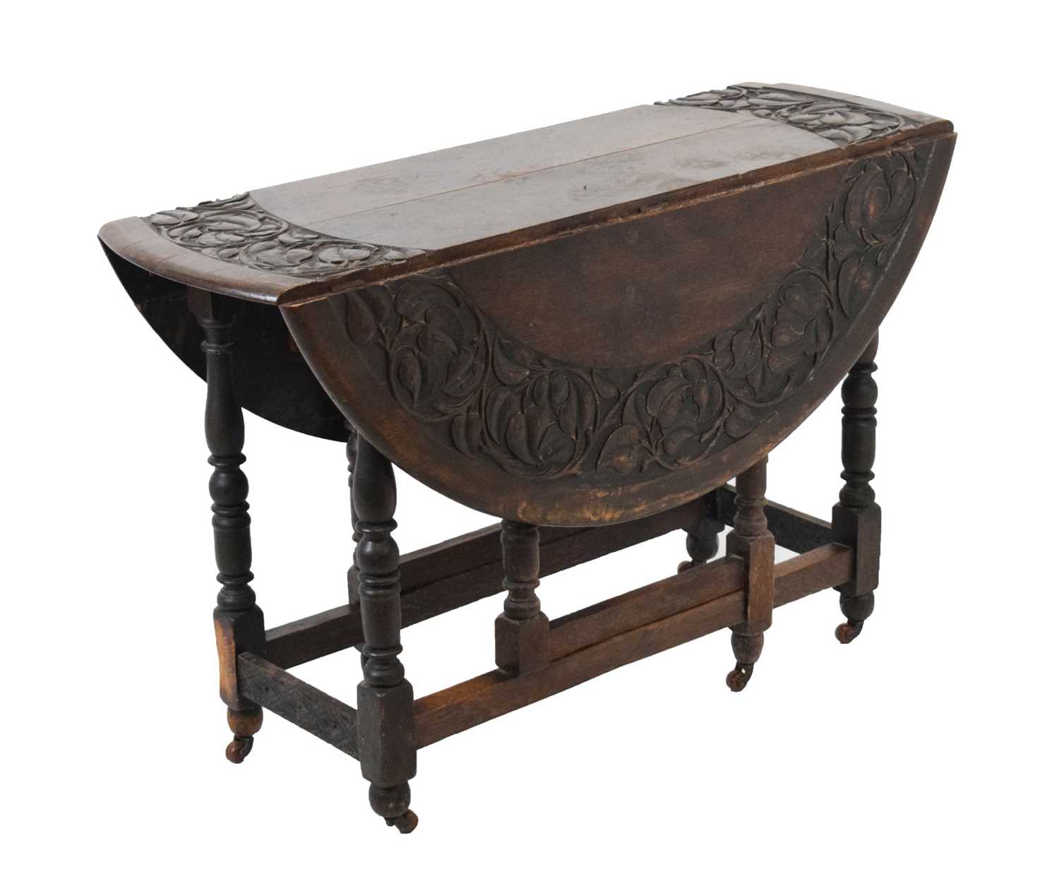 Lot 700 - Early 20th Century oak oval gateleg table, having carved border