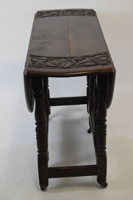 Lot 700 - Early 20th Century oak oval gateleg table, having carved border
