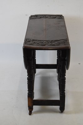Lot 700 - Early 20th Century oak oval gateleg table, having carved border