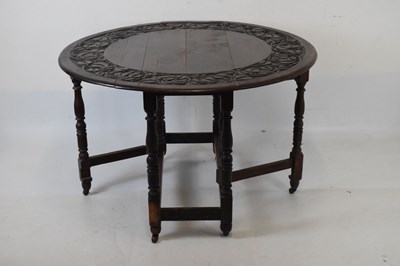 Lot 700 - Early 20th Century oak oval gateleg table, having carved border