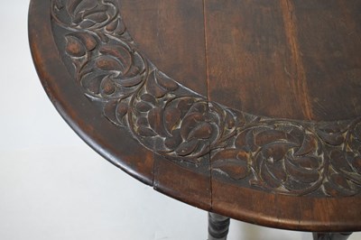 Lot 700 - Early 20th Century oak oval gateleg table, having carved border
