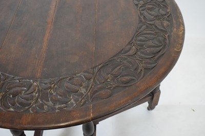 Lot 700 - Early 20th Century oak oval gateleg table, having carved border