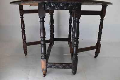Lot 700 - Early 20th Century oak oval gateleg table, having carved border