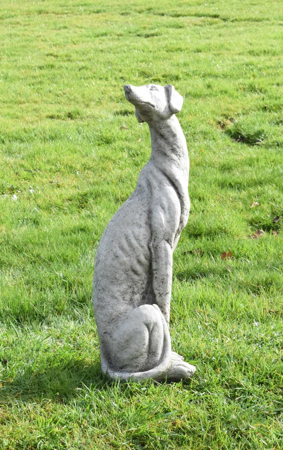 Lot 809 - Composition stone garden ornament of a whippet