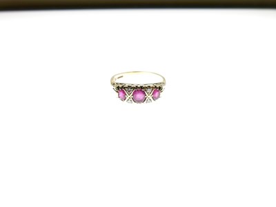 Lot 19 - 18ct gold, ruby, and diamond seven-stone ring