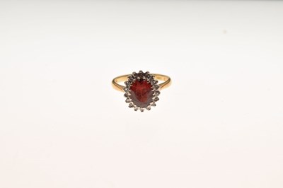 Lot 27 - 18ct gold cluster ring set diamonds and garnet-coloured stone
