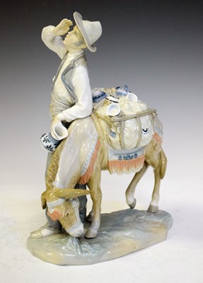 Lot 420 - Lladro - Porcelain figure of man selling pots with a donkey