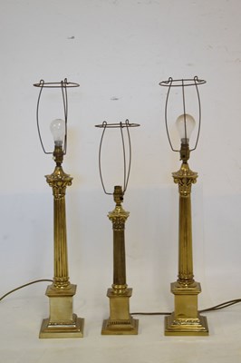 Lot 633 - Three brass Corinthian column table lamps