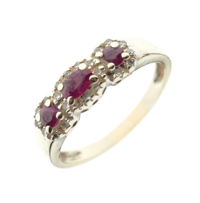 Lot 15 - Unmarked white metal ruby three-stone dress ring