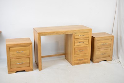 Lot 653 - Light oak desk and pair bedside cabinets