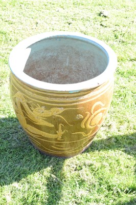Lot 690 - Group of three Chinese brown glazed stoneware urns with dragon decoration