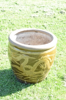 Lot 690 - Group of three Chinese brown glazed stoneware urns with dragon decoration