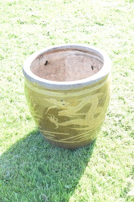 Lot 690 - Group of three Chinese brown glazed stoneware urns with dragon decoration