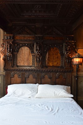 Lot 63 - Impressive carved oak and marquetry-inlaid tester bed