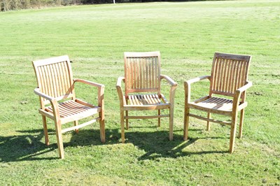 Lot 671 - Three teak garden chairs