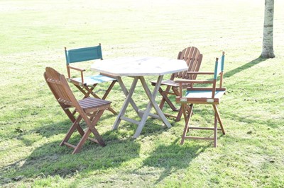 Lot 674 - Teak patio table and a matched set of four garden chairs