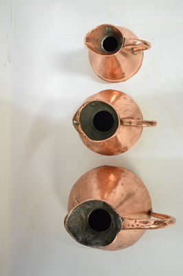 Lot 433 - Set of copper jugs