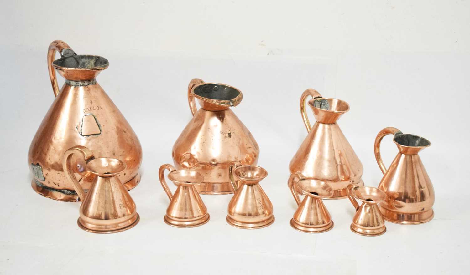 Lot 433 - Set of copper jugs