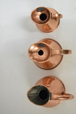 Lot 433 - Set of copper jugs