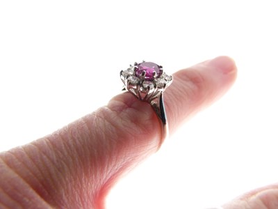 Lot 24 - Ruby and diamond 18ct white gold cluster ring