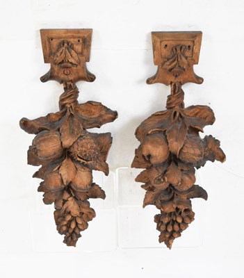 Lot 259 - Pair of carved wooden wall appliqués with fruit decoration, 55cm high