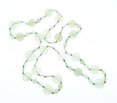Lot 63 - Row of carved pale green jade beads