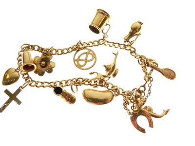 Lot 45 - Yellow metal bracelet with various charms attached
