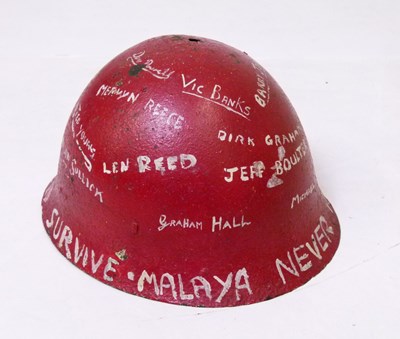 Lot 197 - Malaya Campaign - red painted metal helmet