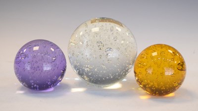 Lot 388 - Three glass paperweights with bubble inclusions