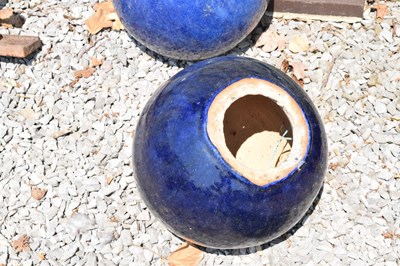 Lot 647 - Pair of glazed blue ceramic garden globes