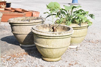 Lot 636 - Three composite stone circular garden planters or pots