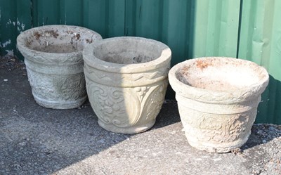 Lot 638 - Three composite stone circular garden planters or pots