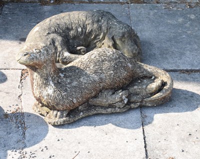 Lot 641 - Composite stone garden figure of a reclining Spaniel  and a figure of an Otter