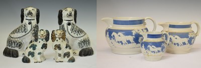 Lot 392 - Two pairs of Staffordshire spaniels, together with three hunting jugs