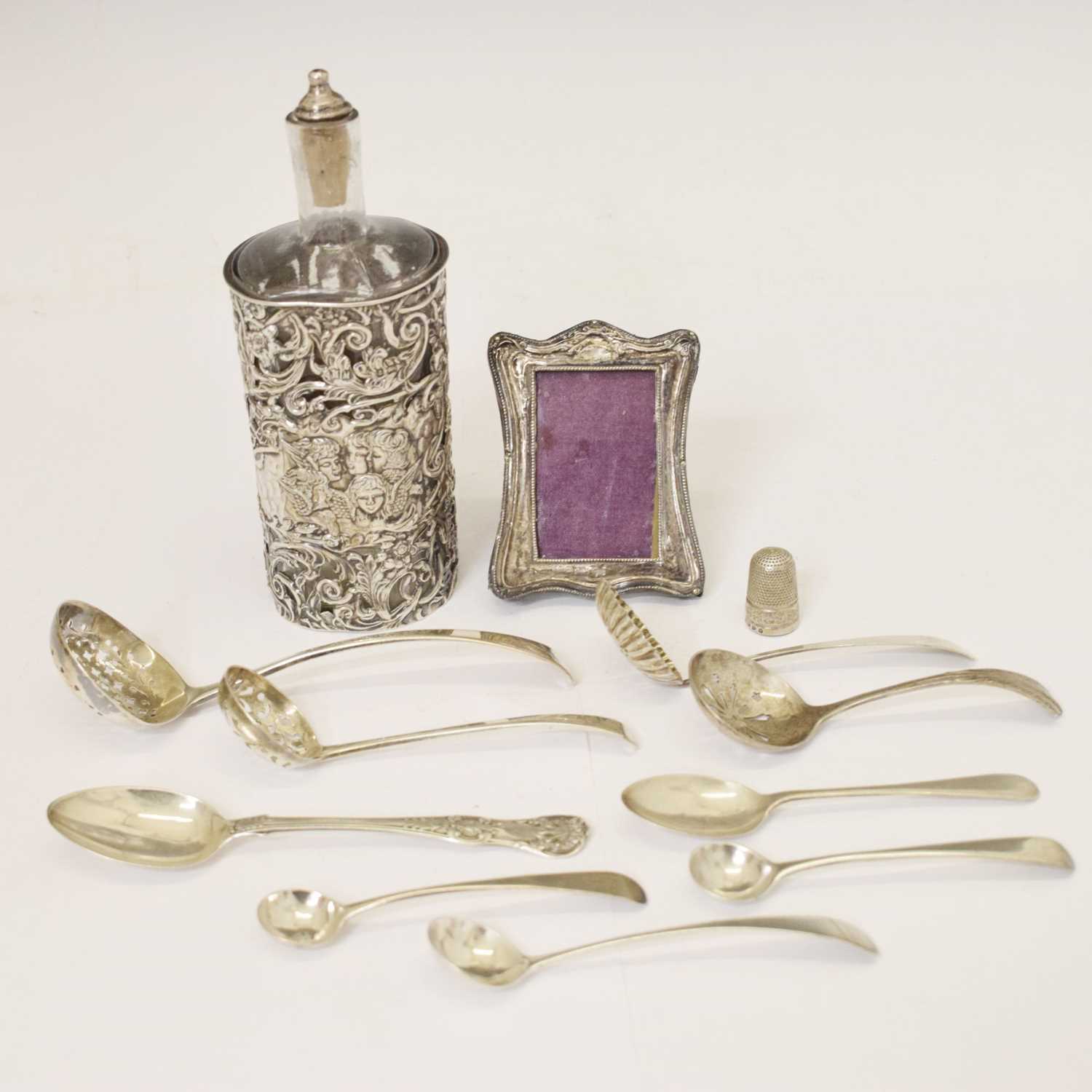 Lot 170 - Edward VII silver-wrapped perfume bottle, photo frame, thimble, assorted sifting spoons, etc