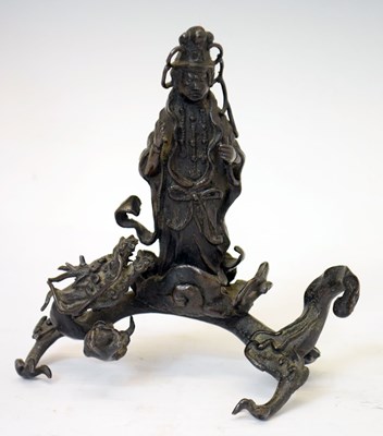 Lot 451 - Bronze figure of Guanyin standing upon a dragon