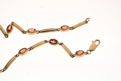 Lot 83 - Yellow metal bracelet set garnet-coloured facetted oval stones