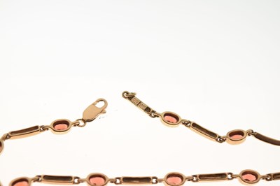 Lot 83 - Yellow metal bracelet set garnet-coloured facetted oval stones