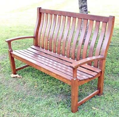 Lot 637 - Teak two seater waved-back garden bench