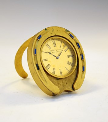 Lot 544 - Asprey & Sons gilt metal and blue enamel 'horseshoe' desk clock