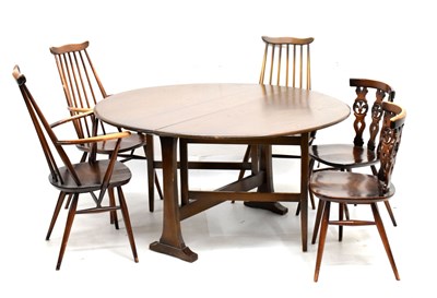 Lot 601 - Ercol drop-leaf dark elm table and chairs