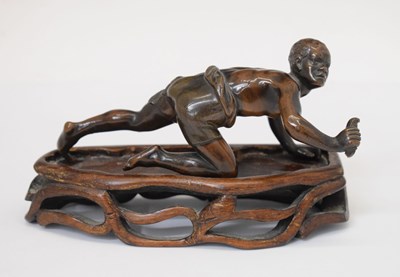 Lot 212 - Bronze of crawling African figure hunting