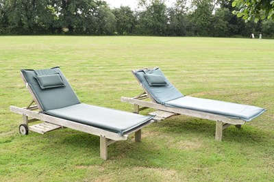 Lot 560 - Pair of teak garden sun loungers