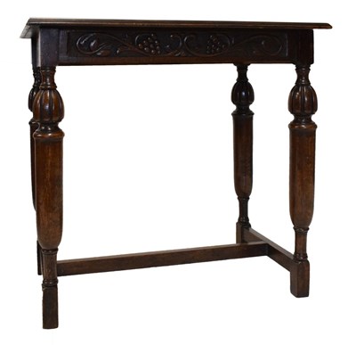 Lot 490 - Dark oak side table with vine frieze