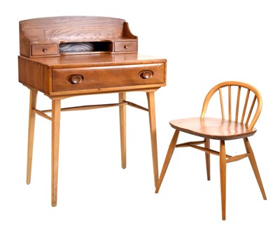 Lot 459 - Ercol  elm desk and chair