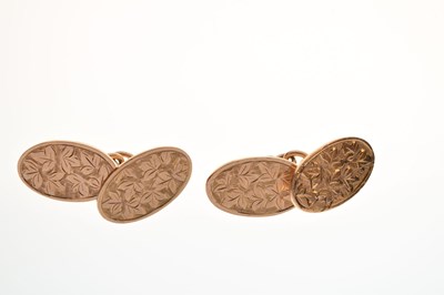 Lot 88 - Pair of 9ct gold foliate engraved oval cufflinks