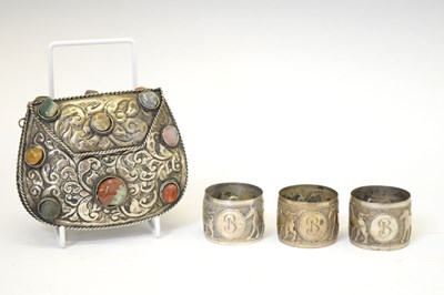 Lot 158 - Three Middle Eastern white metal napkin rings and an unmarked white metal evening purse/bag