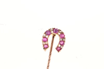 Lot 55 - A diamond and ruby horseshoe stick pin