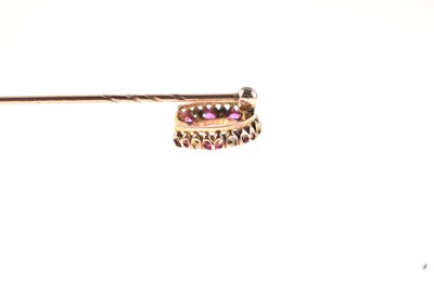 Lot 55 - A diamond and ruby horseshoe stick pin