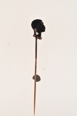 Lot 64 - A carved black onyx bust stick pin